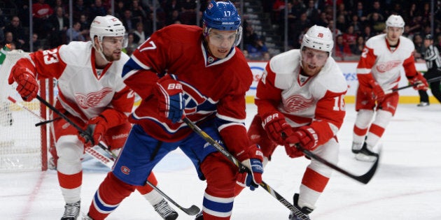 MONTREAL, QC - FEBRUARY 26: Rene Bourque #17 of the Montreal Canadiens controls the puck while being challenged by Brian Lashoff #23 and Joakim Andersson #18 of the Detroit Red Wings during the NHL game on February 26, 2014 at the Bell Centre in Montreal, Quebec, Canada. (Photo by Francois Lacasse/NHLI via Getty Images)