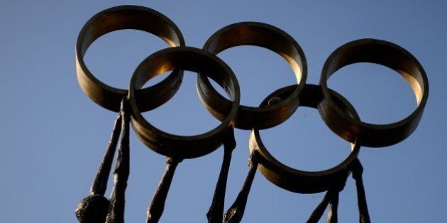 A statue representing people carrying the Olympic Rings is seen on December 10, 2013 at International Olympic Committee (IOC) headquarters in Lausanne. AFP PHOTO / FABRICE COFFRINI (Photo credit should read FABRICE COFFRINI/AFP/Getty Images)