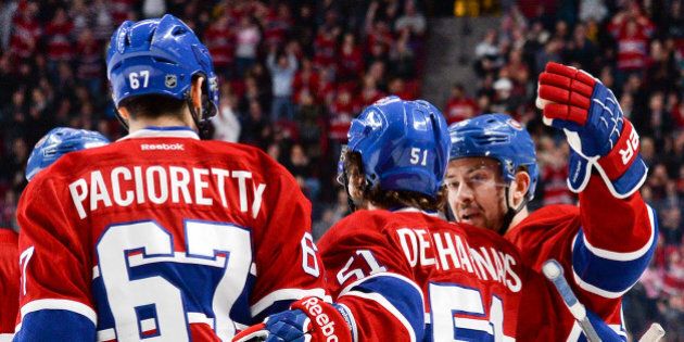 MONTREAL, QC - JANUARY 6: David Desharnais #51 of the Montreal Canadiens, celebrates after scoring a goal against the Florida Panthers with teammates Max Pacioretty #67 and Josh Gorges #26 during the NHL game on January 6, 2014 at the Bell Centre in Montreal, Quebec, Canada. (Photo by Francois Lacasse/NHLI via Getty Images)