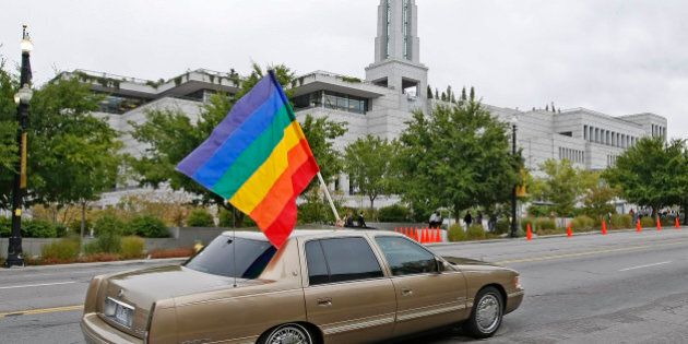 SALT LAKE CITY - OCTOBER 3: A car flies the gay pride flag in protest past the Mormon Conference center during the 179th Semi-Annual General Conference of the Mormon church on October 3, 2009 in Salt Lake City, Utah. Several thousand Mormons are gathering for two days to hear guidance from church leaders. Many gay-rights organizations have criticized the church because of its stance on Proposition 8 in California and its opposition to gay marriage. (Photo by George Frey/Getty Images)