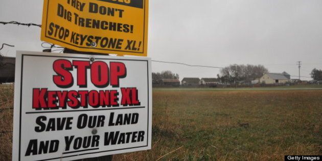 Signs attached to a fence on the property of Jim Tarnick, a farmer opposed to the controversial Keystone XL pipeline, are pictured April 17, 2013 in Fullerton, Nebraska. The fence is on the exact route the pipeline would be on his land. A lengthy battle over the controversial Keystone XL pipeline, which aims to funnel oil from Canada's tar sands to coastal Texas, heads to the most hotly contested area along the route on April 18, 2013. Hundreds of people are expected at a public hearing in Nebraska's environmentally sensitive Sand Hills as the US State Department prepares its recommendation on whether to approve the $5.3 billion project. AFP PHOTO / Guillaume MEYER (Photo credit should read Guillaume Meyer/AFP/Getty Images)