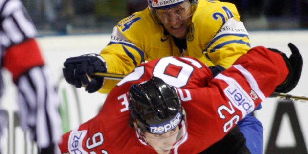 Sweden's Staffan Kronwall, back, fights for a puck with Matt Duchene, front, from Canada during their qualification round group F Hockey World Championships match in Kosice, Slovakia, Monday, May 9, 2011. (AP Photo/Petr David Josek)