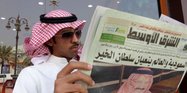 A Saudi man reads Al Sharq Al Awsat newspaper, displaying a picture of the late Saudi Crown Prince Sultan bin Abdul-Aziz Al Saud in Riyadh, Saudi Arabia, Sunday, Oct. 23, 2011. The heir to the Saudi throne, Prince Sultan died abroad Saturday undergoing treatment for illness in New York. The death of the prince, who was in his 80s, opens questions about the succession in the critical, oil-rich U.S. ally. (AP Photo/Hassan Ammar)