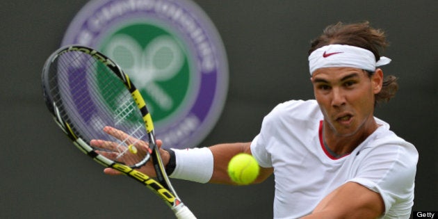 Spain's Rafael Nadal returns against Belgium's Steve Darcis during their men's first round match on day one of the 2013 Wimbledon Championships tennis tournament at the All England Club in Wimbledon, southwest London, on June 24, 2013. AFP PHOTO / BEN STANSALL - RESTRICTED TO EDITORIAL USE (Photo credit should read BEN STANSALL/AFP/Getty Images)