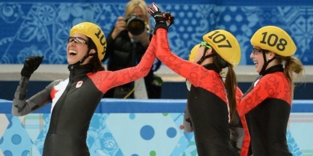 Canada's Marie-Eve Drolet, Jessica Hewitt, Valerie Maltais and Marianne St-Gelais celebate after winning...