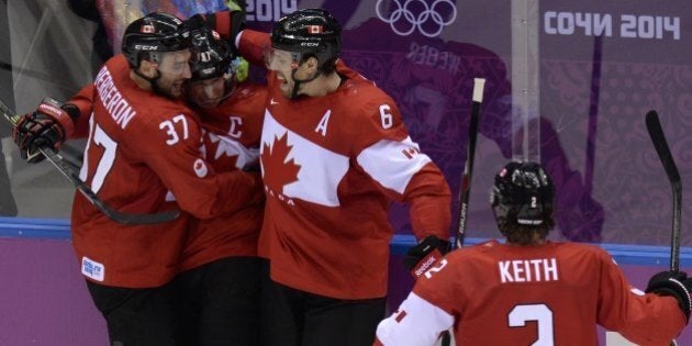 Canada's Sidney Crosby (2L) celebrates with teammates after scoring during the Men's ice hockey final Sweden vs Canada at the Bolshoy Ice Dome during the Sochi Winter Olympics on February 23, 2014. AFP PHOTO / ALEXANDER NEMENOV (Photo credit should read ALEXANDER NEMENOV/AFP/Getty Images)