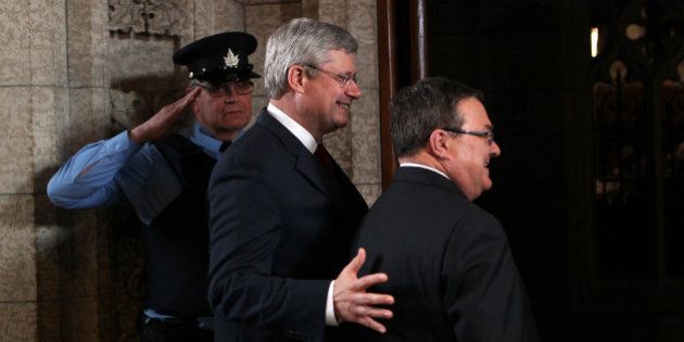 James 'Jim' Flaherty, Canada's finance minister, right, and Stephen Harper, Canada's prime minister, center, arrive to release the 2014 Federal Budget on Parliament Hill in Ottawa, Ontario, Canada, on Tuesday, Feb. 11, 2014. Flaherty ramped up efforts to return the country to surplus in a budget that raises taxes on cigarettes and cuts benefits to retired government workers while providing more aid for carmakers. Photographer: Cole Burston/Bloomberg via Getty Images