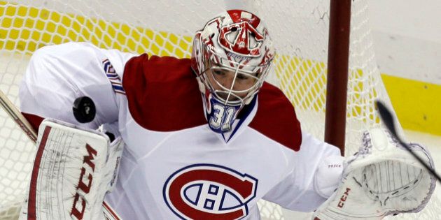 Montreal Canadiens goalie Carey Price (31) stops a shot against the Pittsburgh Penguins in the first period of an NHL hockey game in Pittsburgh Tuesday, March 26, 2013. (AP Photo/Gene J. Puskar)