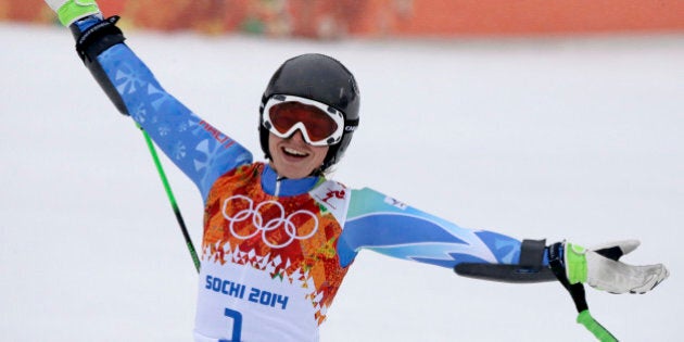 Slovenia's Tina Maze celebrates after taking the lead in the second run of the women's giant slalom at...