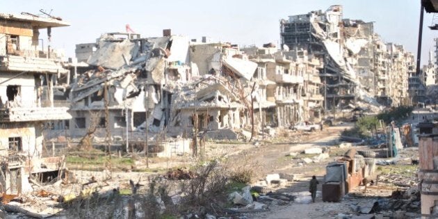 Civilians leave the the besieged district of the central Syrian city of Homs ahead of being evacuated by United Nations (UN) staff to a safer location, on February 9, 2014. Aid teams evacuated hundreds of exhausted civilians from besieged districts of the city of Homs, as Syria's regime and rebels again accused each other of violating a truce. AFP PHOTO / BASSEL TAWIL (Photo credit should read BASSEL TAWIL/AFP/Getty Images)