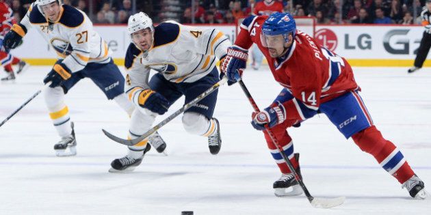 MONTREAL, QC - DECEMBER 7: Tomas Plekanec #14 of the Montreal Canadiens, controls the puck while being challenged by Jamie McBain #4 and Matt D'Agostini #27 of the Buffalo Sabres during the NHL game on December 7, 2013 at the Bell Centre in Montreal, Quebec, Canada. (Photo by Francois Lacasse/NHLI via Getty Images)
