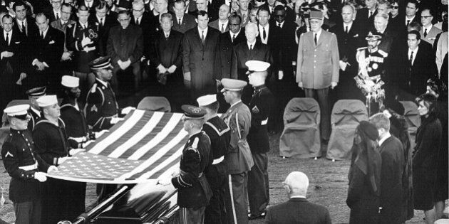 381091 61: Honor guard place a flag over the casket of President John F. Kennedy during his funeral service November 25, 1963 in Arlington Cemetery. (Photo by National Archive/Newsmakers)