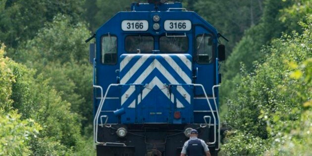 LAC-MEGANTIC QC - JULY 9:An RCMP officer secures a grouping of locomotives that were involved in the Lac-MÈgantic derailment on the tracks leading to the crash sight. The area is being considered a crime scene. (Lucas Oleniuk/Toronto Star via Getty Images)