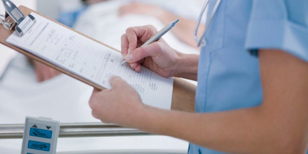 Nurse tending patient in intensive care