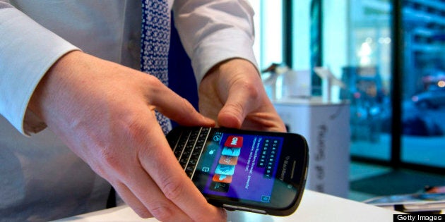 Geoffrey Newsome, sales consultant, prepares to install a BlackBerry Q10 for display at a Bell Canada retail location in Toronto, Canada, on Tuesday, April 30, 2013. BlackBerry, the Canadian smartphone maker, climbed to its highest level in more than a month after Chief Executive Officer Thorsten Heins said he sees sales of its new Q10 device to be in the 'tens of millions.' Photographer: Galit Rodan/Bloomberg via Getty Images