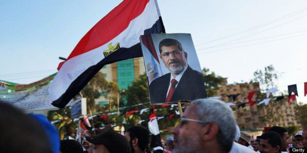 CAIRO, EGYPT - JULY 11: Supporters of ousted president Mohamed Morsi attend a rally before breaking the daily Ramadan fast on the second day of Ramadan, the sacred holy month for Muslims where many will fast from sun-up to sun-down on July 11, 2013 in Cairo, Egypt. Egypt continues to be in a state of political paralysis following the ousting of former President and Muslim Brotherhood leader Mohamed Morsi by the military. Adly Mansour, chief justice of the Supreme Constitutional Court, was sworn in as the interim head of state in a ceremony in Cairo on the morning of July 4. (Photo by Spencer Platt/Getty Images)