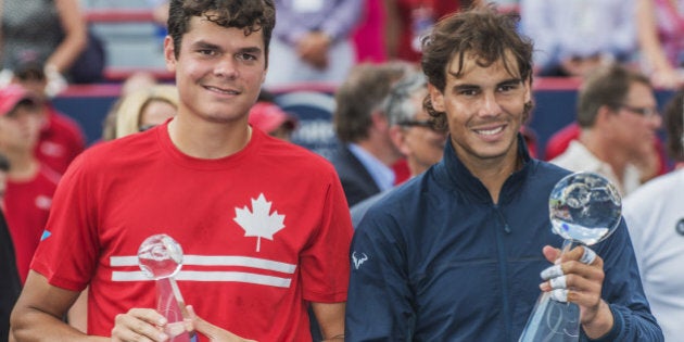 Milos Raonic of Canada (L) and Rafael Nadal of Spain (R) posing for the media after their final match at the Uniprix Stadium during the ATP Rogers Cup on August 11, 2013 in Montreal, Quebec, Canada. AFP PHOTO / ROGERIO BARBOSA (Photo credit should read ROGERIO BARBOSA/AFP/Getty Images)