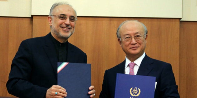 Head of Iran's Atomic Energy Organisation Ali Akbar Salehi (L) and International Atomic Energy Agency (IAEA) Director General Yukiya Amano, pose for a photo following their meeting in Tehran on November 11, 2013. Amano arrived in the Iranian capital to discuss Iran's nuclear programme after top world diplomats fail to clinch a long-sought deal to curb Tehran's nuclear activities but insist they are narrowing the gaps. AFP PHOTO/ATTA KENARE (Photo credit should read ATTA KENARE/AFP/Getty Images)