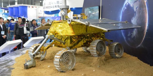 A model of a lunar rover that will explore the moon's surface in an upcoming space mission is seen on display at the China International Industry Fair 2013 in Shanghai on November 5, 2013. The rover's designer, Shanghai Aerospace Systems Engineering Research Institute, said the real thing would be lifted aloft by a Long March 3B rocket scheduled to be launched in early December. AFP PHOTO/Peter PARKS (Photo credit should read PETER PARKS/AFP/Getty Images)