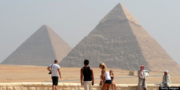 Foreign tourists visit the Giza pyramids, south of the Egyptian capital Cairo, on October 1, 2012. AFP PHOTO/KHALED DESOUKI (Photo credit should read KHALED DESOUKI/AFP/GettyImages)