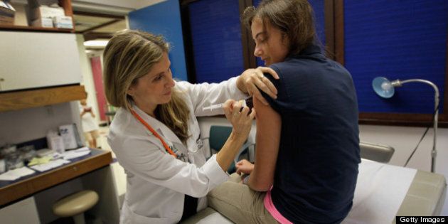 MIAMI, FL - SEPTEMBER 21: University of Miami pediatrician Judith L. Schaechter, M.D. (L) gives an HPV vaccination to a 13-year-old girl in her office at the Miller School of Medicine on September 21, 2011 in Miami, Florida. The vaccine for human papillomavirus, or HPV, is given to prevent a sexually transmitted infection that can cause cancer. Recently the issue of the vaccination came up during the Republican race for president when Rep. Michele Bachmann (R-MN) called the vaccine to prevent cervical cancer 'dangerous' and said that it may cause mental retardation, but expert opinion in the medical field contradicts her claim. Texas Gov. Rick Perry, also a presidential contender, has taken heat from some within his party for presiding over a vaccination program in his home state. (Photo by Joe Raedle/Getty Images)