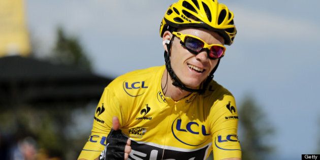 Stage's third placed overall leader's yellow jersey Britain's Christopher Froome thumbs up as he crosses the finish line at the end of the 125 km twentieth stage of the 100th edition of the Tour de France cycling race on July 20, 2013 between Annecy and Annecy-Semnoz, French Alps. AFP PHOTO / JEFF PACHOUD (Photo credit should read JEFF PACHOUD/AFP/Getty Images)