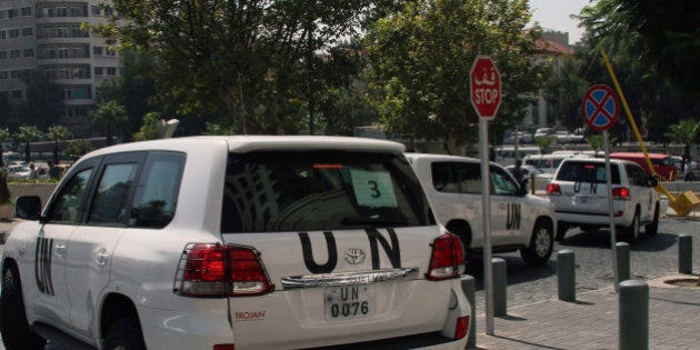 A convoy of United Nations (UN) vehicles leave a hotel in Damascus on August 26, 2013 carrying UN inspectors travelling to the site of a suspected deadly chemical weapon attack the previous week in Ghouta, east of the capital. The Syrian authorities approved the UN inspection of the site, but US officials said it was too little, too late, arguing that persistent shelling there in recent days had 'corrupted' the site. AFP PHOTO / STR (Photo credit should read STR/AFP/Getty Images)