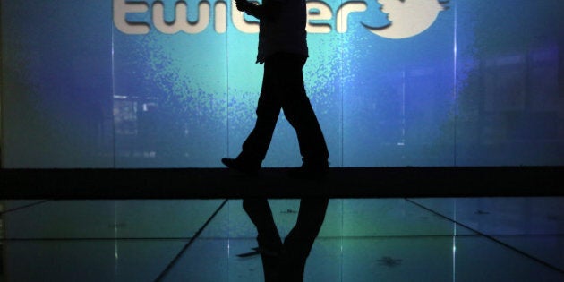 A user checks a Twitter feed on a smartphone in this arranged photograph taken in London, U.K., on Friday, Oct. 4, 2013. Twitter Inc.'s initial public offering documents suggested a valuation of $12.8 billion for the microblogging service, underscoring the seven-year rise of a still unprofitable company that has helped revolutionize how people share information. Photographer: Chris Ratcliffe/Bloomberg via Getty Images