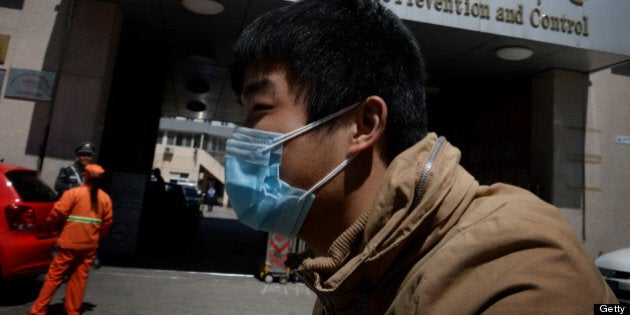 A Chinese man arrives at the Beijing Center for Disease Prevention and Control as the country deals with the H7N9 bird flu virus on April 18, 2013. China has confirmed a total of 82 human cases of H7N9 avian influenza since announcing about two weeks ago that it had found the strain in people for the first time. Health authorities in China say they do not know exactly how the virus is spreading, but it is believed to be crossing to humans from birds, triggering mass poultry culls in several cities. AFP PHOTO/Mark RALSTON (Photo credit should read MARK RALSTON/AFP/Getty Images)