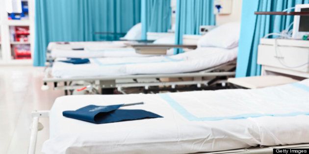 Empty hospital beds in a surgery recovery area.