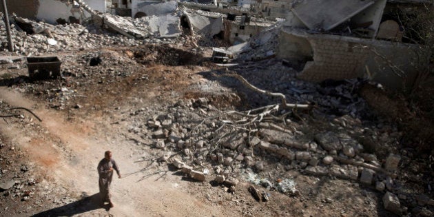 A man walks through a destroyed residential area of the Syrian city of Saraqib, southwest of Aleppo, on September 9, 2013, following repeated airstrikes by government forces' fighter jets. US President Barack Obama and his Russian counterpart Vladimir Putin discussed the idea of placing Syrian chemical weapons under international control at last week's G20 summit in Saint Petersburg, Putin's spokesman said on September 10, 2013. AFP PHOTO / GIOVANNI DIFFIDENTI (Photo credit should read GIOVANNI DIFFIDENTI/AFP/Getty Images)