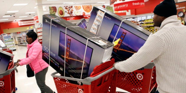 Customers pick up shopping carts containing Element Electronics 50-inch light-emitting diode (LED) high definition televisions at a Target Corp. store opening ahead of Black Friday in Chicago, Illinois, U.S., on Thursday, Nov. 28, 2013. U.S. retailers will kick off holiday shopping earlier than ever this year as stores prepare to sell some discounted items at a loss in a battle for consumers. Photographer: Patrick T. Fallon/Bloomberg via Getty Images