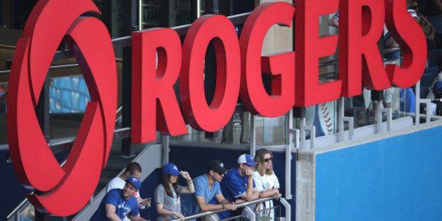 TORONTO, CANADA - MAY 20: Toronto Blue Jays fans watch the game from the outfield standing section under the Rogers logo during MLB game action against the Tampa Bay Rays on May 20, 2013 at Rogers Centre in Toronto, Ontario, Canada. (Photo by Tom Szczerbowski/Getty Images)