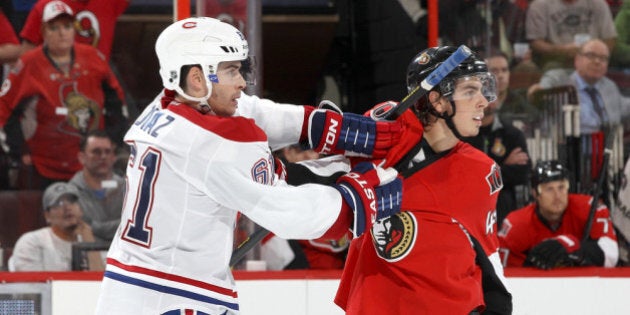 OTTAWA, ON - SEPTEMBER 25: Jean-Gabriel Pageau #44 of the Ottawa Senators is held by Raphael Diaz #61 of the Montreal Canadiens as they watch a fight during an NHL pre-season game at Canadian Tire Centre on September 25, 2013 in Ottawa, Ontario, Canada. (Photo by Jana Chytilova/Freestyle Photography/Getty Images)