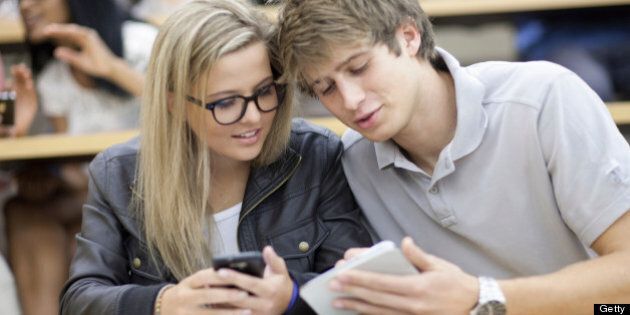 Two students looking at smartphone