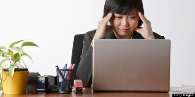 business woman looking stressed at computer