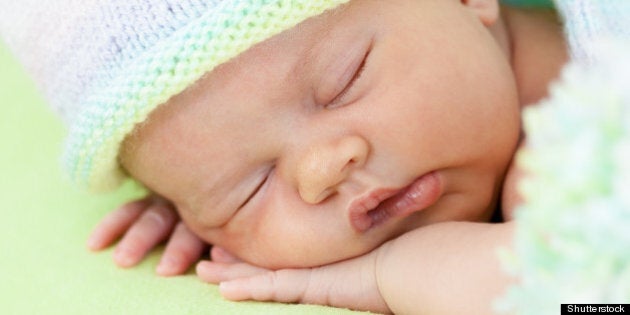 adorable baby in cap sleeping...