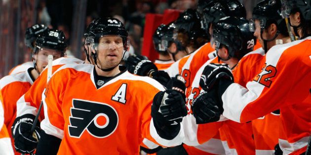PHILADELPHIA, PA - MARCH 31: Kimmo Timonen #44 of the Philadelphia Flyers is congratulated by teammates after he scored a goal to tie the game late in the third period of an NHL hockey game against the Washington Capitals at Wells Fargo Center on March 31, 2013 in Philadelphia, Pennsylvania. Flyers won 5-4 in overtime. (Photo by Paul Bereswill/Getty Images)