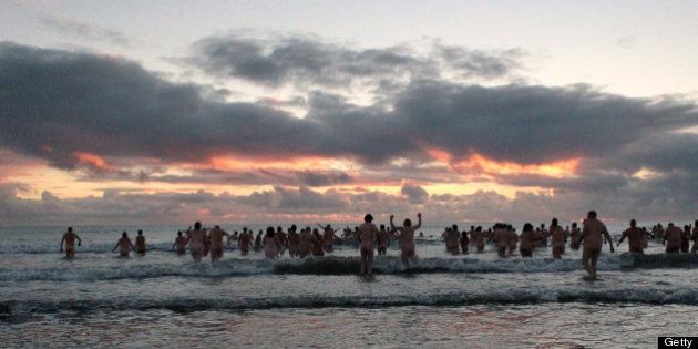 Nudists take part in the North East Skinny Dip at Druridge Bay in Northumberland, at sunrise on September 22, 2012. Over 200 bathers braved the cold in an attempt to break the World Record for the largest skinny-dip. The record still stands at over 400, set at Rhossili Beach in Wales. AFP PHOTO/LINDSEY PARNABY (Photo credit should read LINDSEY PARNABY/AFP/GettyImages)
