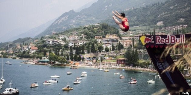 MALCESINE, ITALY - JULY 13: (EDITORIAL USE ONLY) In this handout image provided by Red Bull, Stephanie de Lima of Canada dives from the 20 metre platform at the Scaliger Castle during the first Red Bull Cliff Diving Women's Competition on July 13, 2013 at Malcesine, Italy. (Photo by Romina Amato/Red Bull via Getty Images)