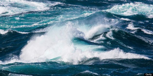 Powerful ocean waves on rocky waters