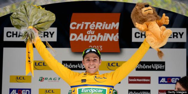 Stage winner Canada's David Veilleux celebrates his overall leader yellow jersey on the podium at the end of the 121 km first stage of the 65th edition of the Dauphine Criterium cycling race on June 2, 2013 in Champery, Switzerland. AFP PHOTO / JEFF PACHOUD (Photo credit should read JEFF PACHOUD/AFP/Getty Images)