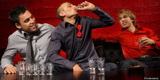 men drinking shots in night club