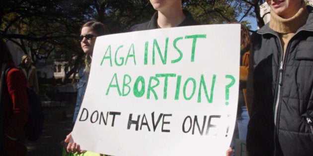 AUSTIN, TX - NOVEMBER 24: Students from the University of Texas hold signs during a rally in favor of abortion rights November 24,2003 in Austin, Texas. The rally was organized by students in light of recent national political developments, such as the passage of the 'partial birth abortion' prohibition, and local developments, which include the stoppage of the construction of a Planned Parenthood clinic by pro-life supporters. (Photo by Jana Birchum/Getty Images)