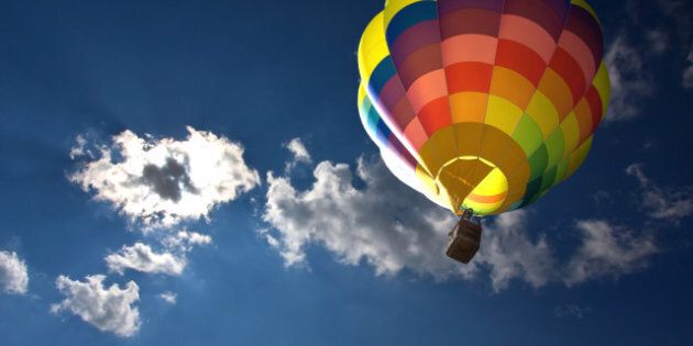 Hot air balloon in the blue sky and clouds