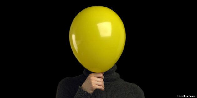 a yellow balloon over a persons ...