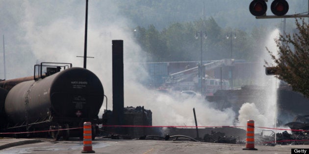 Wreckage continues to burn on July 7, 2013 after a freight train loaded with oil derailed July 6 in Lac-Megantic in Canada's Quebec province, sparking explosions that engulfed about 30 buildings in a wall of fire. Now scores of people -- perhaps as many as 80 -- are missing. Rescuers cautiously entered the charred debris Sunday, more than 24 hours after the spectacular crash that saw flames shoot into the sky and burn into the night. The accident and resulting huge fireball forced 2,000 people from their homes. Witnesses reported up to six explosions after the train derailed at about 1:20 am (0520 GMT Saturday) in Lac-Megantic. AFP PHOTO / François Laplante-Delagrave (Photo credit should read François Laplante-Delagrave/AFP/Getty Images)