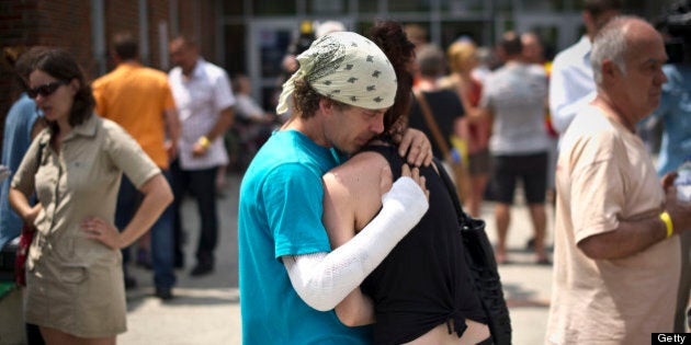 LAC-MEGANTIC QC - JULY 7: Bernard Theberge consoles a friend who was displaced by the train derailment in Lac-MÈgantic. Theberge was badly burned during the explosion as he fled a downtown patio bar. Five people have now been declared dead and dozens remain missing after a train derailment caused a massive explosion in the quaint Quebec town of Lac-MÈgantic. (Lucas Oleniuk/Toronto Star via Getty Images)