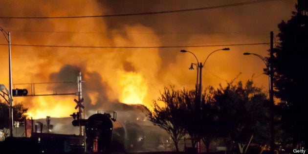 Firefighters douse blazes after a freight train loaded with oil derailed in Lac-Megantic in Canada's Quebec province on July 6, 2013, sparking explosions that engulfed about 30 buildings in fire. At least 80 people are missing after a driverless oil tanker train derailed and exploded in the small Canadian town of Lac-Megantic, destroying dozens of buildings, a firefighter back from the scene told AFP. AFP PHOTO / François Laplante-Delagrave (Photo credit should read François Laplante-Delagrave/AFP/Getty Images)