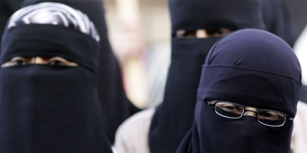 BLACKBURN, UNITED KINGDOM - OCTOBER 14: Muslim women wearing niqab and burqa veils protest outside Bangor Street Community centre where Leader of the House of Commons Jack Straw is holding one of his weekend surgery appointments where he faced a protest by around 50 Muslim protesters on October 14, 2006, Blackburn, England. Jack Straw made comments last week regarding his view that veils such as the Burqa and Niqab split communities. (Photo by Christopher Furlong/Getty Images)